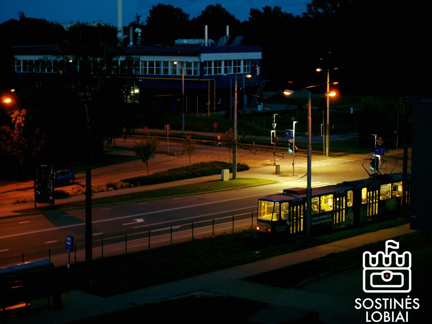 May be an image of 1 person, trolley, lighting, street and text